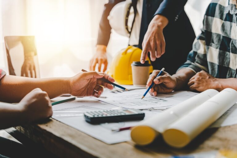 A team of engineers reviewing plans