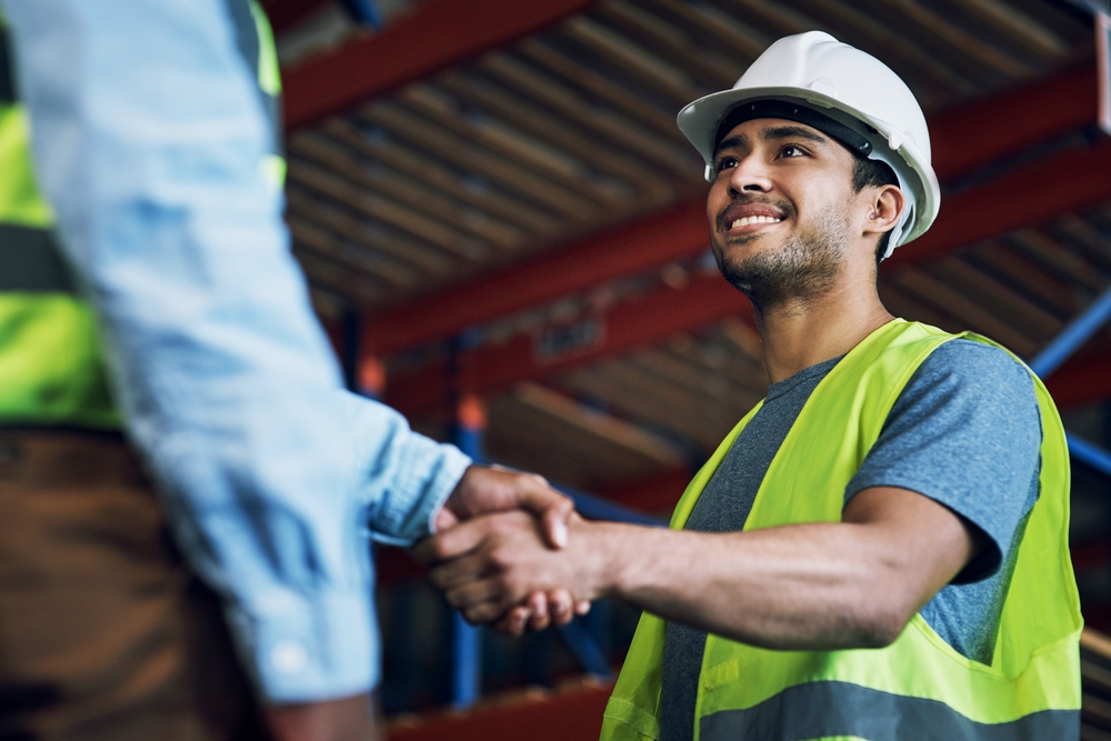 Happy man, architect and handshake for construction, building or hiring in teamwork or partnership on site. Business people shaking hands in recruiting, architecture agreement or engineer deal