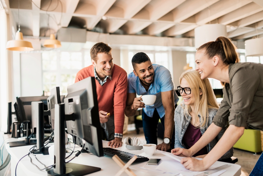 Young and diverse group of engineers working together on a project in a startup company office