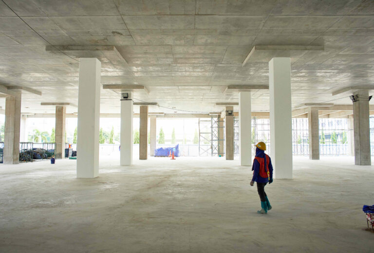 man walking through commercial construction site