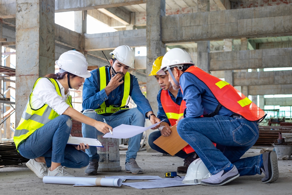 group of construction workers examining plans