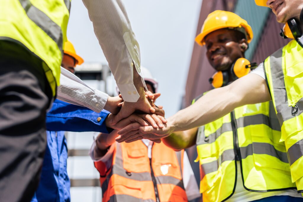 Group of manufacturing workers shaking hands