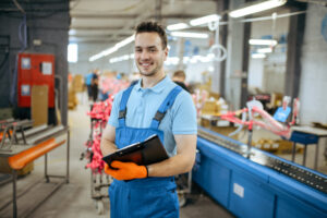 Employee smiling, holding clipboard