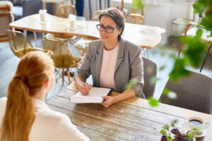 Woman conducting job interview in a cafe.