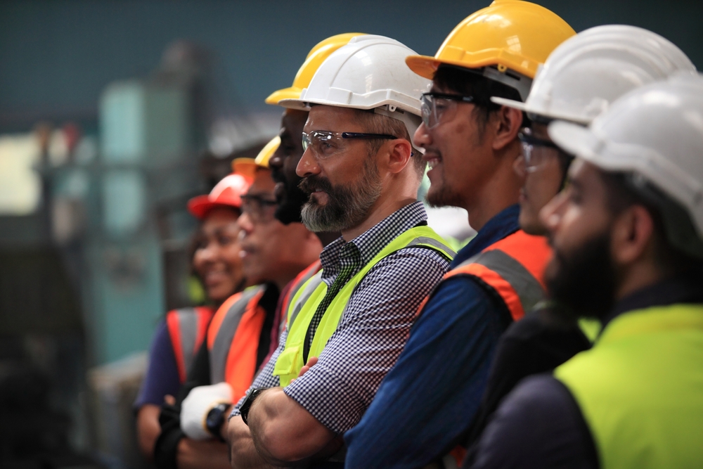 The diverse engineering team stands lined up confidently