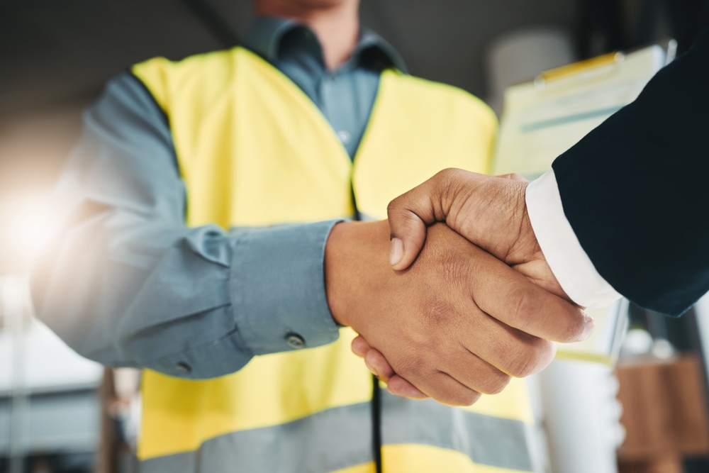 Technician shakes hands with corporate