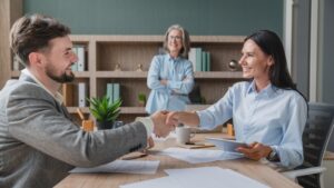 Interviewer shaking hands with engineering job candidate