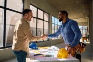 Engineer and project manager shaking hands, mechanical engineer team